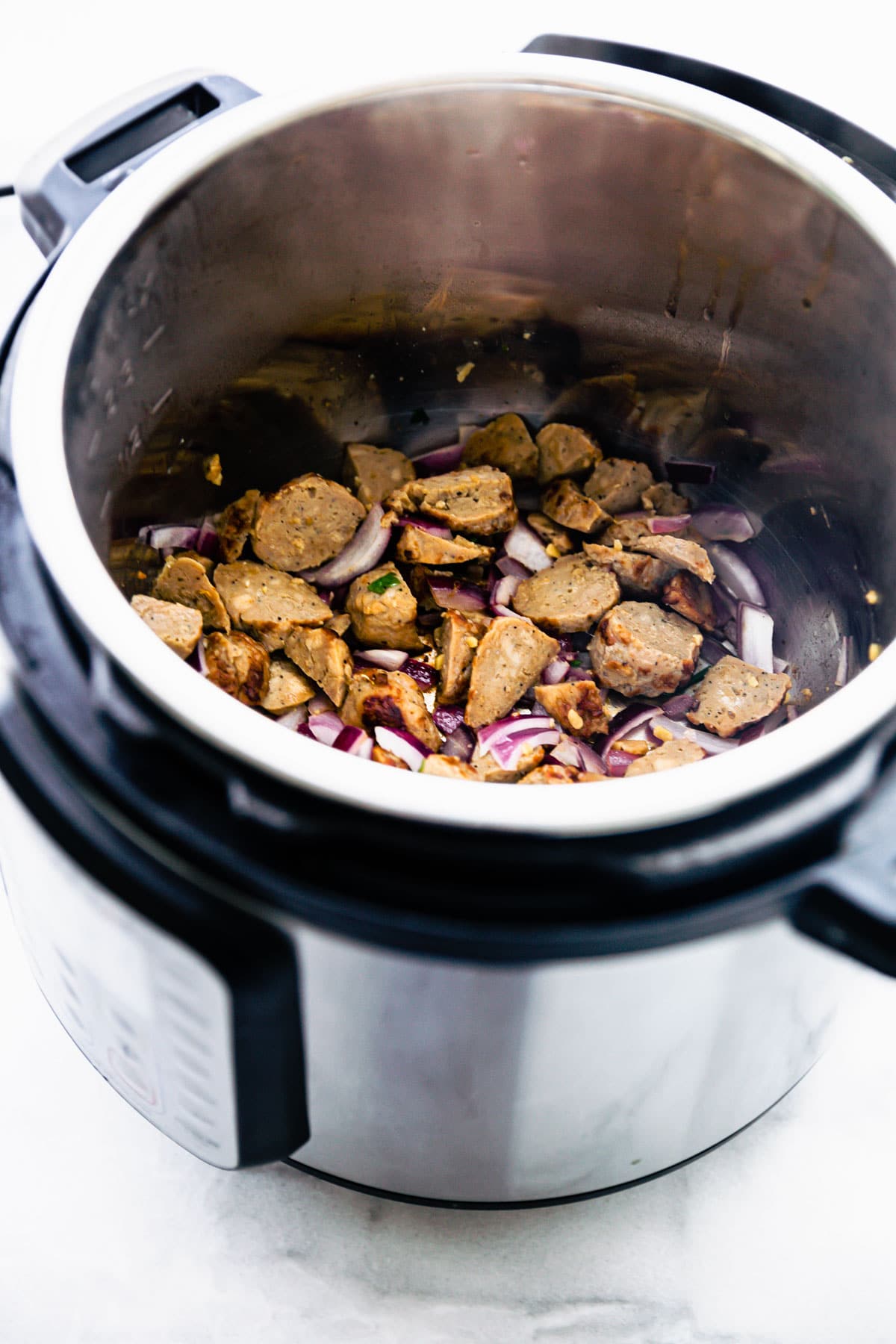 Sausage pieces in Instant Pot cooking.