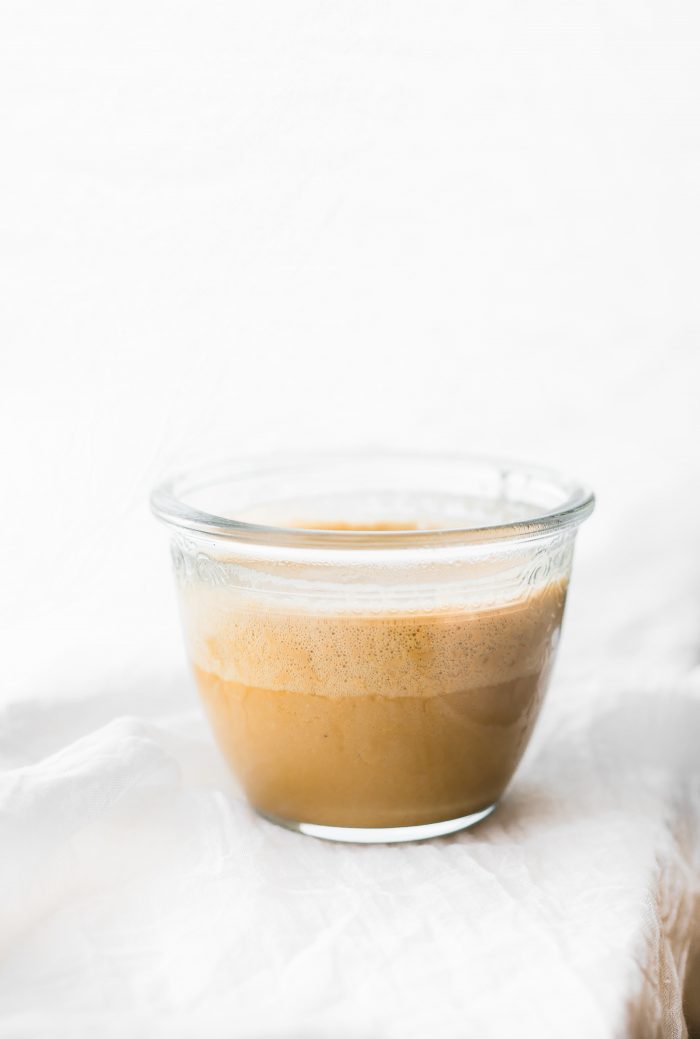 Short glass filled with Bulletproof Coffee latte