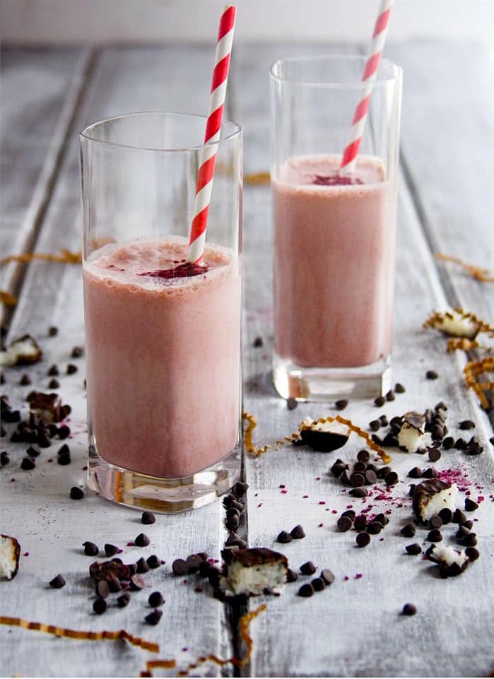 Craving an Almond joy candy bar? Try this layered Chocolate Almond Coconut and Strawberry Ice Cream smoothie that is vegan, gluten free, and tastes just like the real deal; only better for you. Th Perfect healthy substitute for a milkshake too!