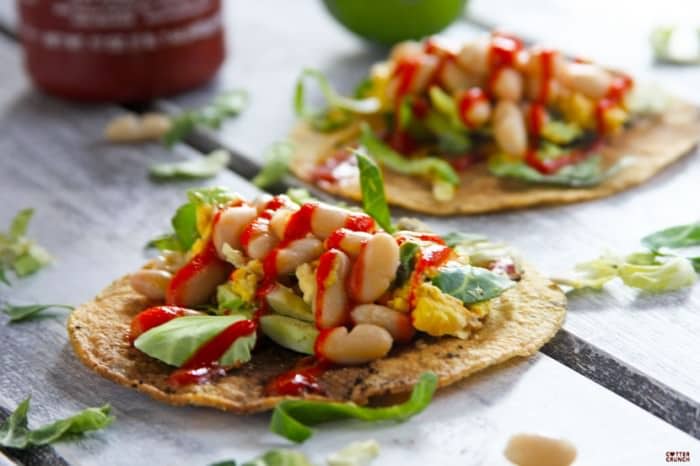 This Gluten Free Tostadas recipe is made with egg and white beans, and it's topped with a spicy chili sauce. It's a great vegetarian meal any time of day!