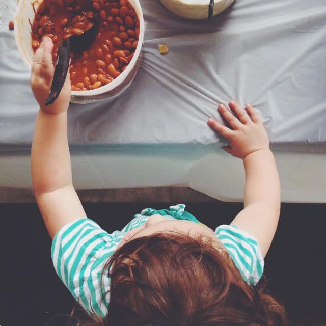 little girl in kitchen, making BBQ beans