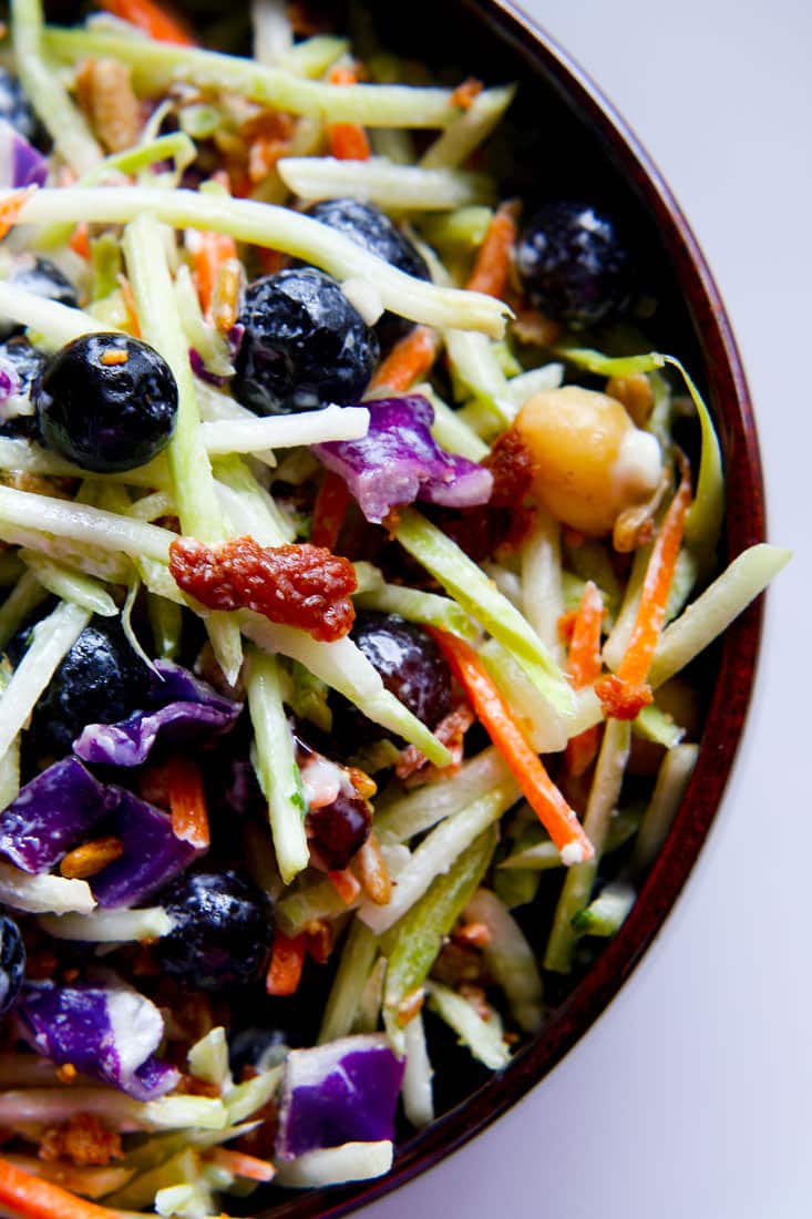 Perfectly Creamy and Tart Broccoli Slaw Salad with Blueberries. It’s packed with antioxidants and probiotics! The tang comes from using a kefir and greek yogurt blend instead of mayo. Which also makes it healthy and gut friendly. Super clean eating with great flavor!