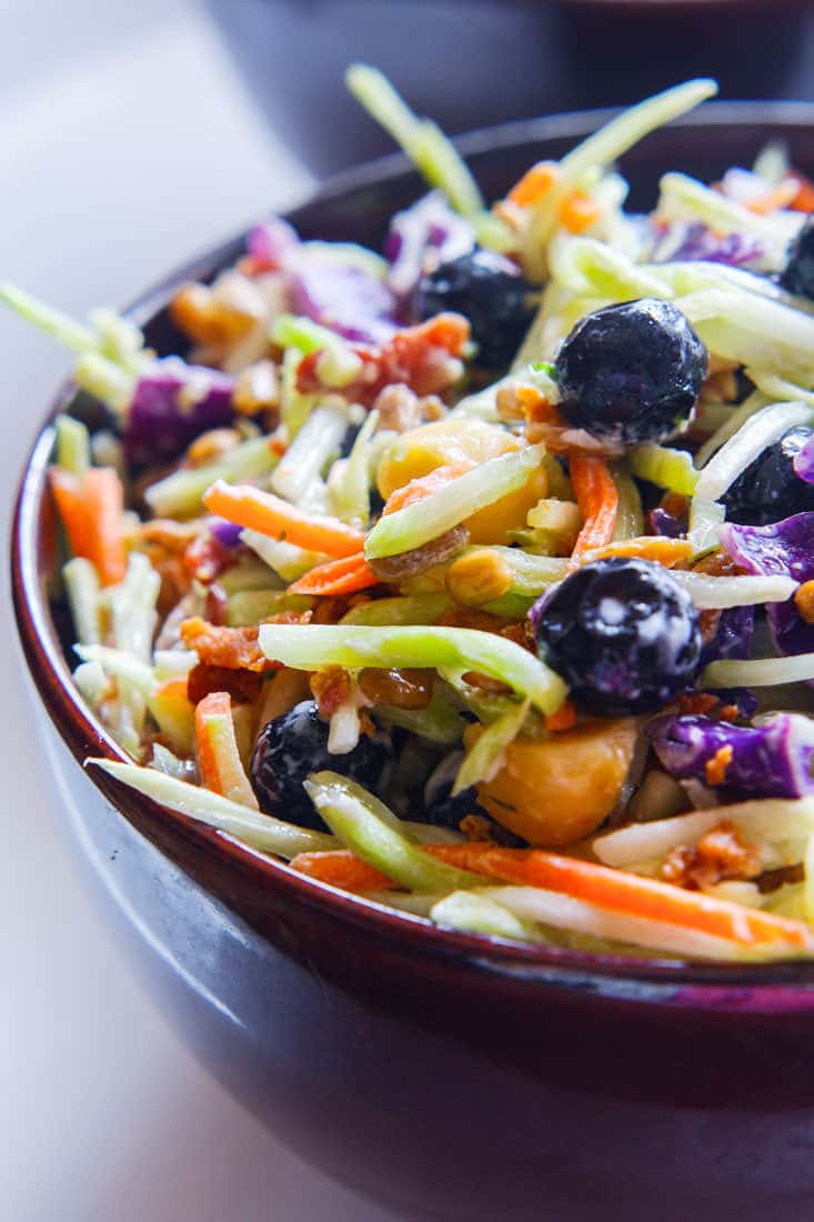Perfectly Creamy and Tart Broccoli Slaw Salad with Blueberries. It’s packed with antioxidants and probiotics! The tang comes from using a kefir and greek yogurt blend instead of mayo. Which also makes it healthy and gut friendly. Super clean eating with great flavor!