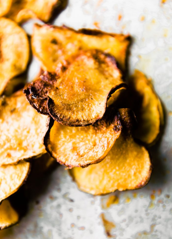 Thin baked rutabaga chips on counter.