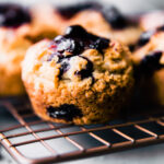 gluten free blueberry muffin sitting on wire cooling rack
