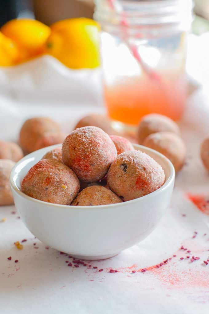 Grain Free Kid friendly Pink Lemonade Protein bites! Lemonade is Summer staple in many homes these days and these refreshing protein bites just might be another a great addition! Lower sugar, protein packed, dairy free, no bake, and Vitamin C rich! Great for snacking on the go, between sports and activities, or anytime of day!