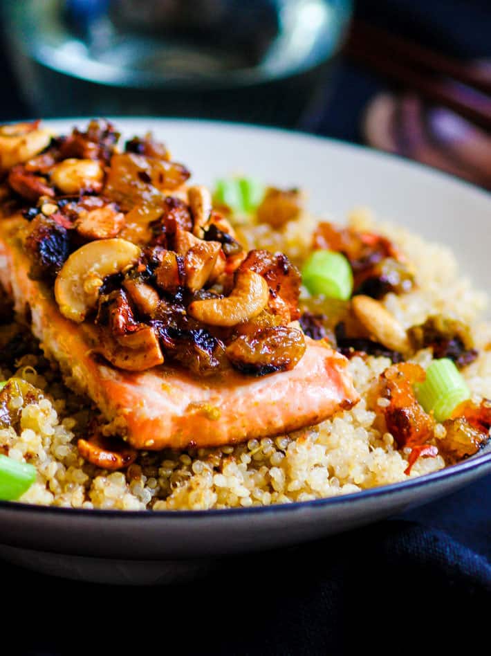 Green Curry Salmon and Cashew with Quinoa! Sweet and spicy green curry combined with cashews, salmon, and dried fruit! A healthy flavorful meal that is packed with anti-oxidants and comes together in 30 minutes! Great by itself or served on top of garlic quinoa!