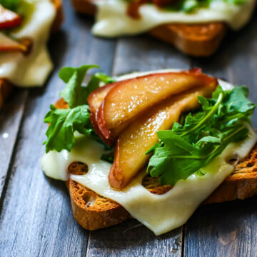 Honey balsamic-glazed pears with Swiss Cheese and arugula on Gluten Free Rye toast! A delicious vegetarian meal great for a quick lunch, appetizer, or even a post workout snack! Balanced with whole grain gluten free carbs, protein, and healthy fats!