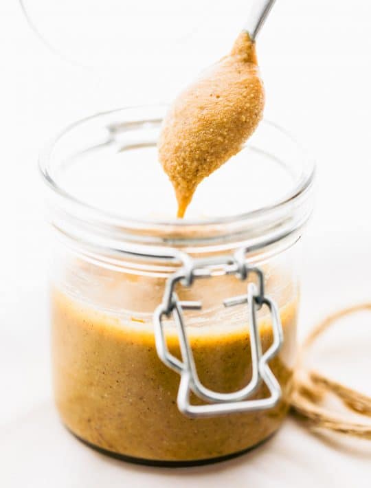 A spoonful of cashew butter over a jar of butter
