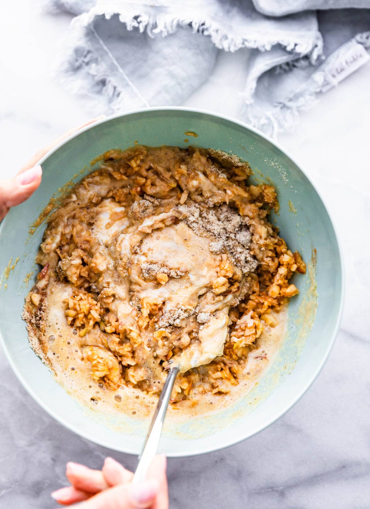 Apple coffee cake batter in light blue mixing bowl