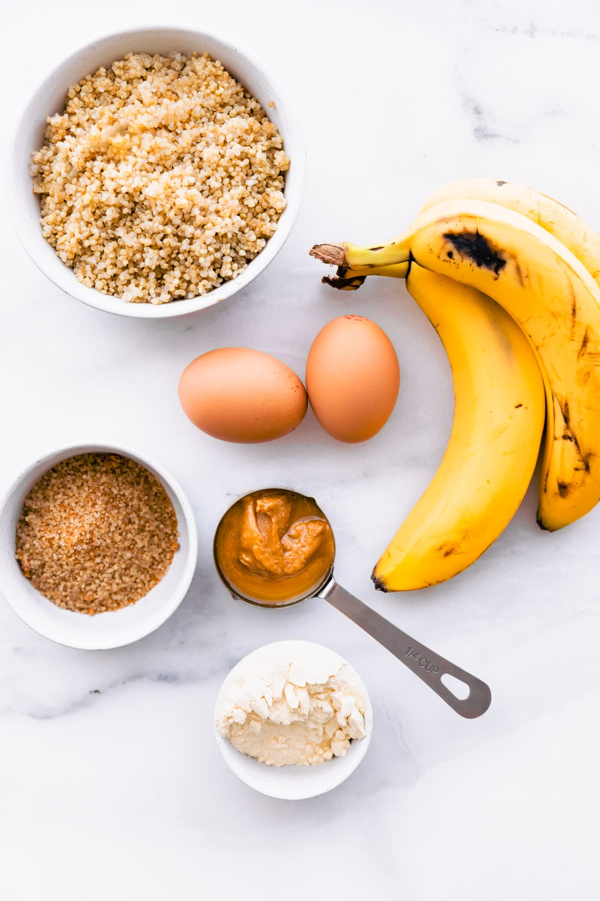 ingredients for gluten free banana bread arranged together with white background