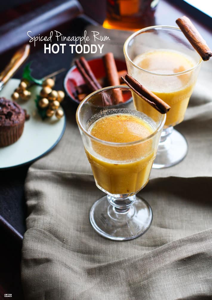 Warm up and stay cozy with this Spiced Pineapple Rum Hot Toddy! It's the perfect festive Fall/Winter drink to soothe the body or to simply enjoy with good company. This spiced pineapple rum hot toddy is made with natural sugars and a touch of cinnamon and coconut milk for healthier Holiday sipping! @cottercrunch