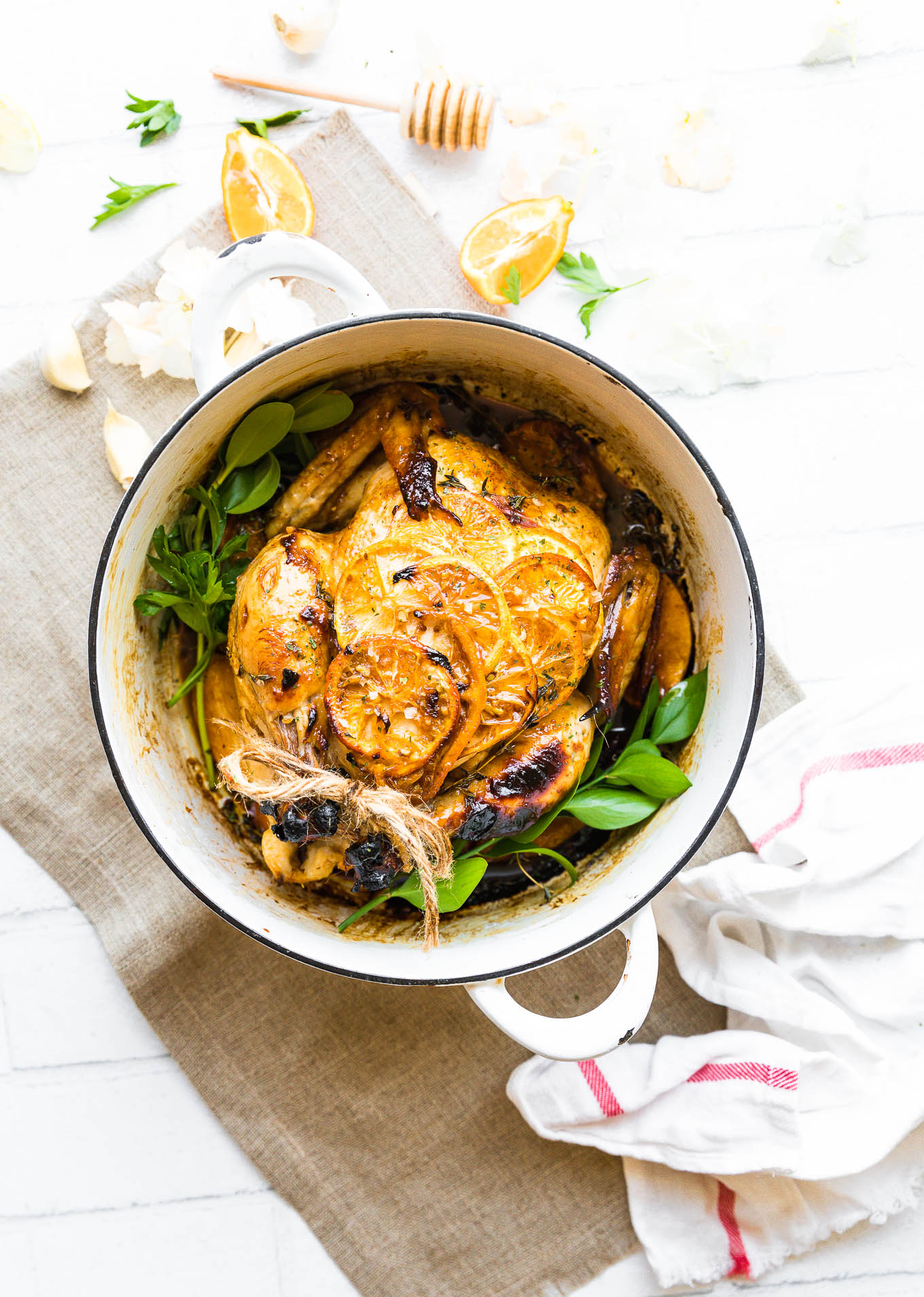 Overhead view roasted chicken with honey and orange glaze in pot.