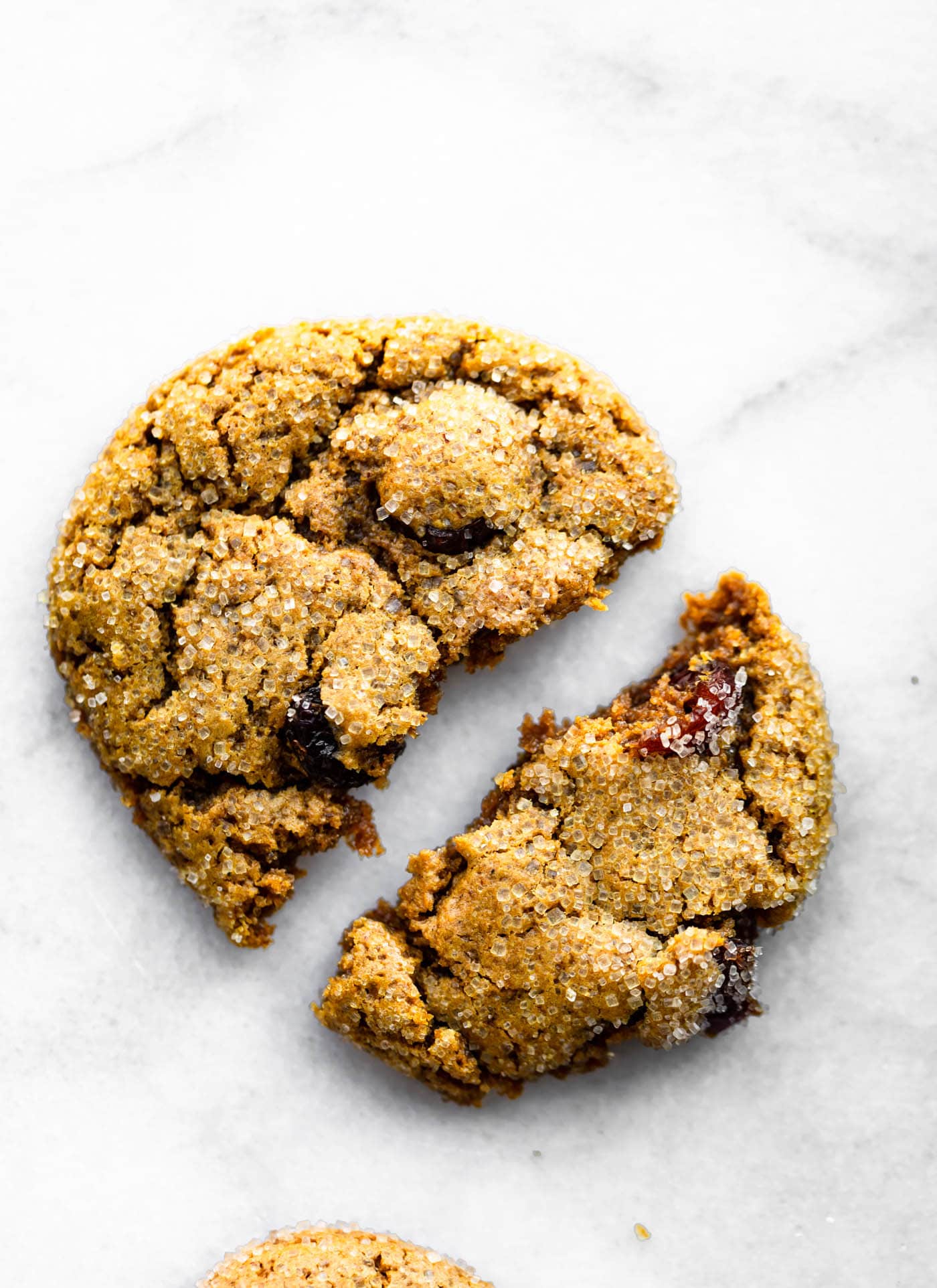 Vegan cranberry almond molasses cookie split in half