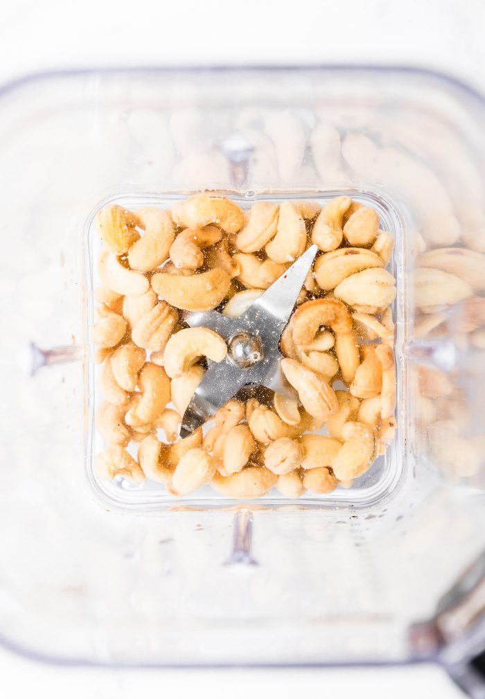 Overhead view of blender with cashews in water
