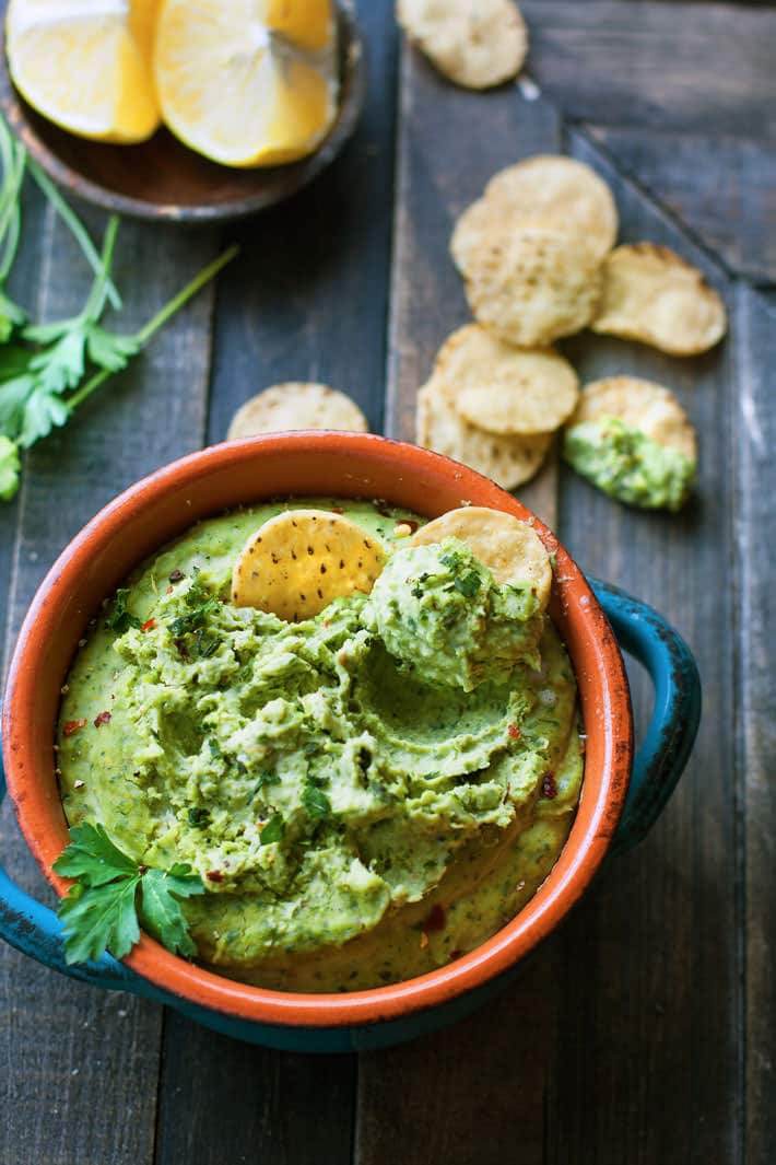 Easy Chimichurri White Bean Hummus. A healthy gluten free white bean hummus that is bursting with flavor and color! So simple to make, vegan friendly, and a total crowd pleaser appetizer or snack! PS It has some major health perks too.