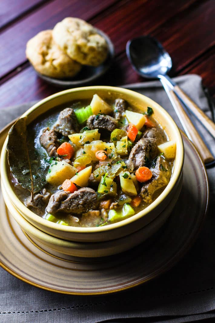 One pot Bacon Braised Lamb Stew! This healthy gluten free Lamb stew is PACKED full of flavor! And I promise it's easy! Let's just say the bacon and lamb combo together do wonders. As do the veggie packed nourishment. Great for family dinners, freezer friendly, and paleo friendly.