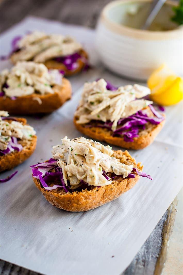Gluten Free Crock Pot Chicken Salad Sandwich Sliders! Tangy Crock Pot Chicken Salad on open faced sandwich sliders! These crock pot chicken recipe is healthy, easy, mayo free, and egg free ! So good for a quick meal, light lunch, appetizer, or food prep for the week. 