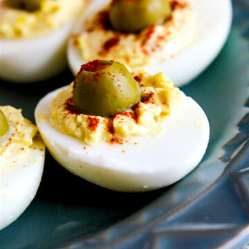 creamy deviled eggs with green olive in center