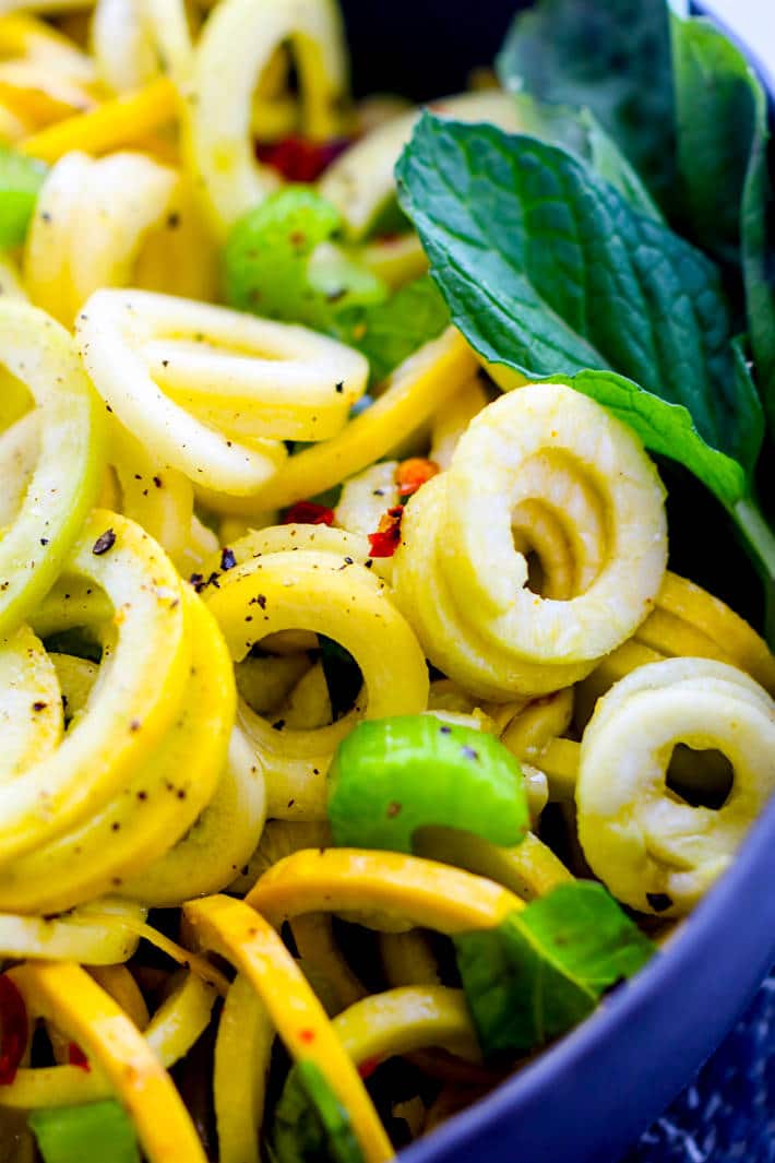 Simple, healthy, nourishing! Paleo and Vegan Basil Mint Yellow Squash Spiralized Salad. REAL FOOD ingredients combined to make one beautiful spiralized salad! A naturally gluten free veggie salad bursting with flavor, nutrients, and color