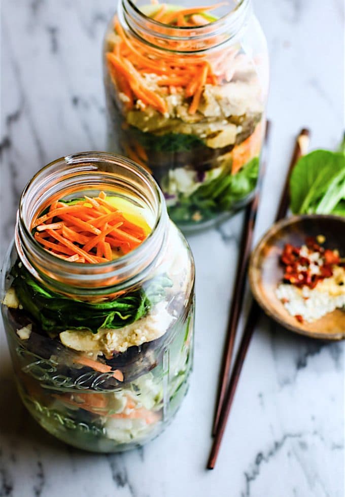 mason jar salads made with gluten free leftovers on wooden background
