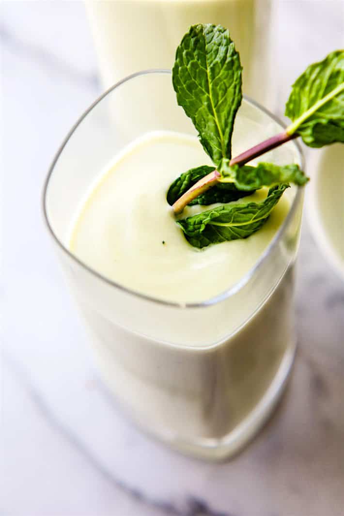 Vegan Creamy Vanilla Coconut Mojito Smoothie plus a Nonalcoholic Fauxjito Option! A delicious and more nutritious cocktail/mocktail you can get on board with. Refreshing coconut mojito smoothie with creamy avocado, vanilla, maple syrup, coconut milk, lime, and mint.