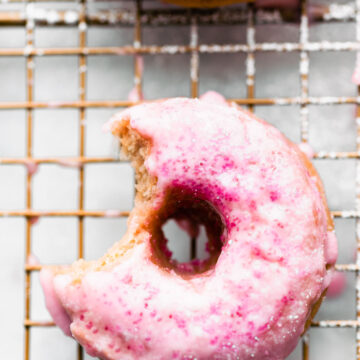 gluten free strawberry cake donut with bite taken out of it