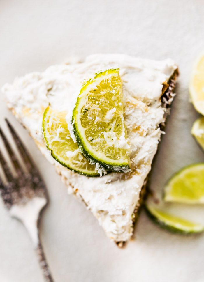Super EASY gluten free lemon lime coconut vegan cake topped with fluffy whipped coconut cream frosting. An allergy friendly vegan cake that's perfect for Spring/Summer and so simple to make! All you need are a few REAL FOOD ingredients and 45 minutes to bake.