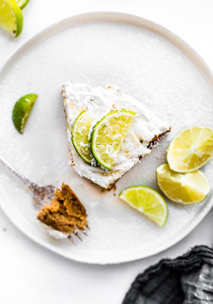 Super EASY gluten free lemon lime coconut vegan cake topped with fluffy whipped coconut cream frosting. An allergy friendly vegan cake that's perfect for Any season. So simple to make! All you need are a few REAL FOOD ingredients and 45 minutes to bake. 