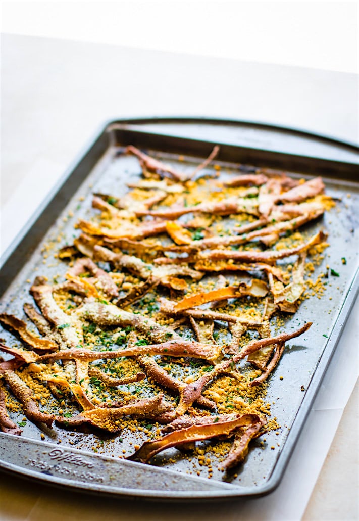 Healthy Oven Baked Parmesan Sweet Potato Skin Fries! Super simple oven baked sweet potato skin fries made from leftover potato skin peels. Easy to make with ANY root vegetable and paleo friendly.