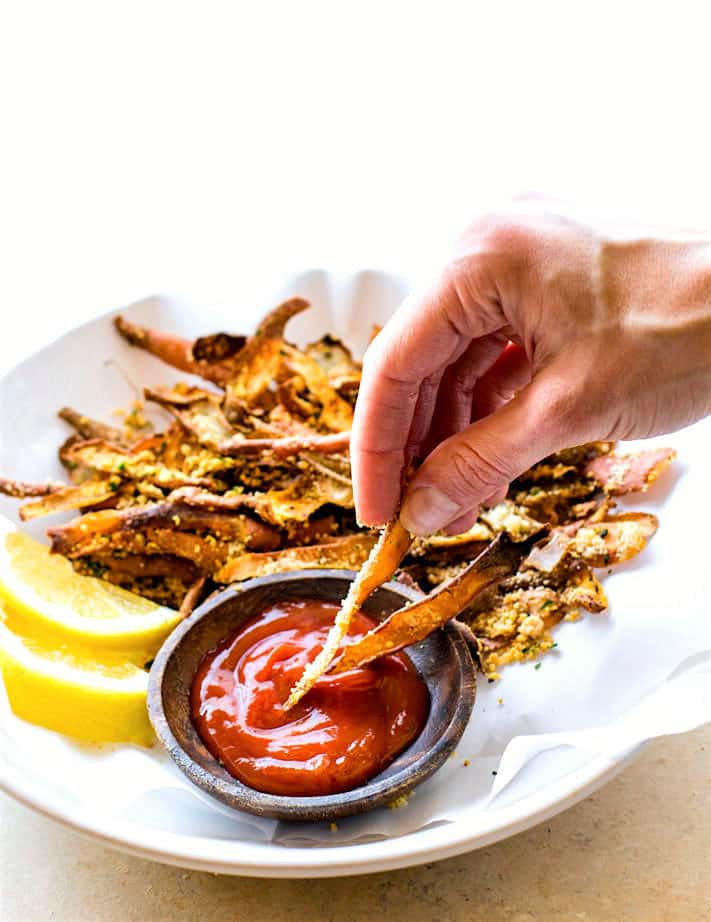 Healthy Oven Baked Parmesan Sweet Potato Skin Fries! Super simple oven baked sweet potato skin fries made from leftover potato skin peels. So crunchy, easy to make, and paleo friendly. Great snack or side dish that everyone loves!