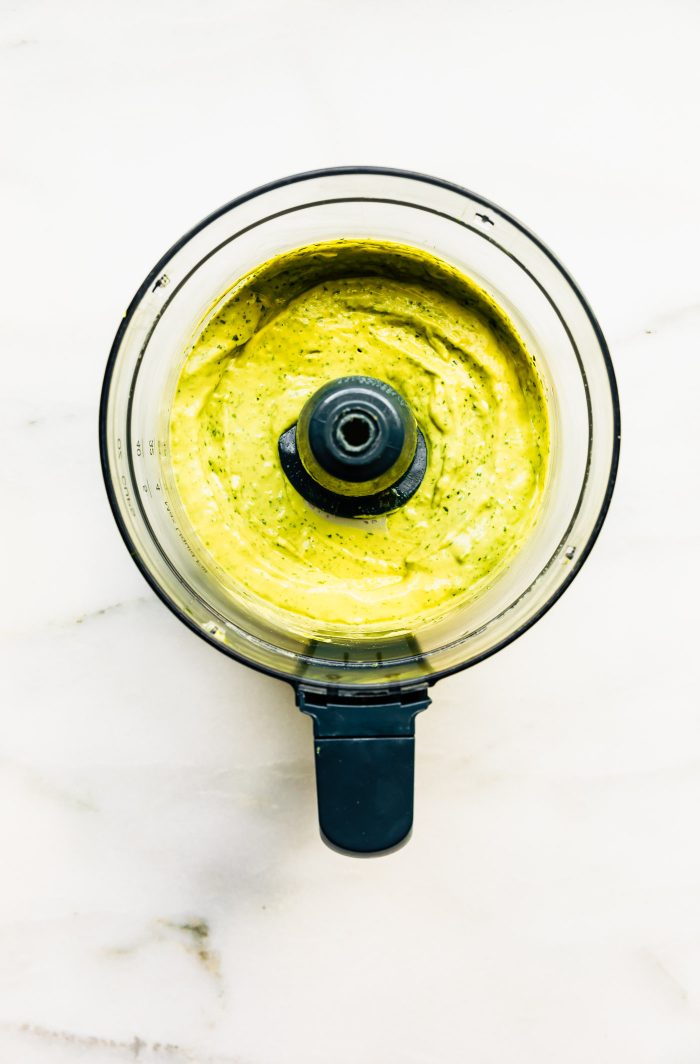 Overhead image of green goddess puree in a blender.