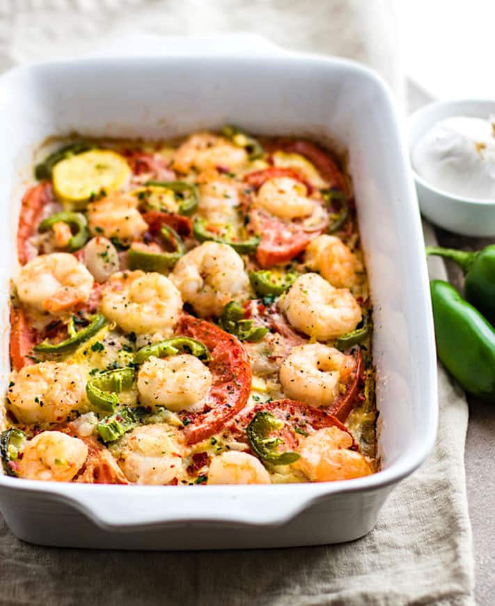 A white casserole dish filled with spicy jalapeño veggie bake