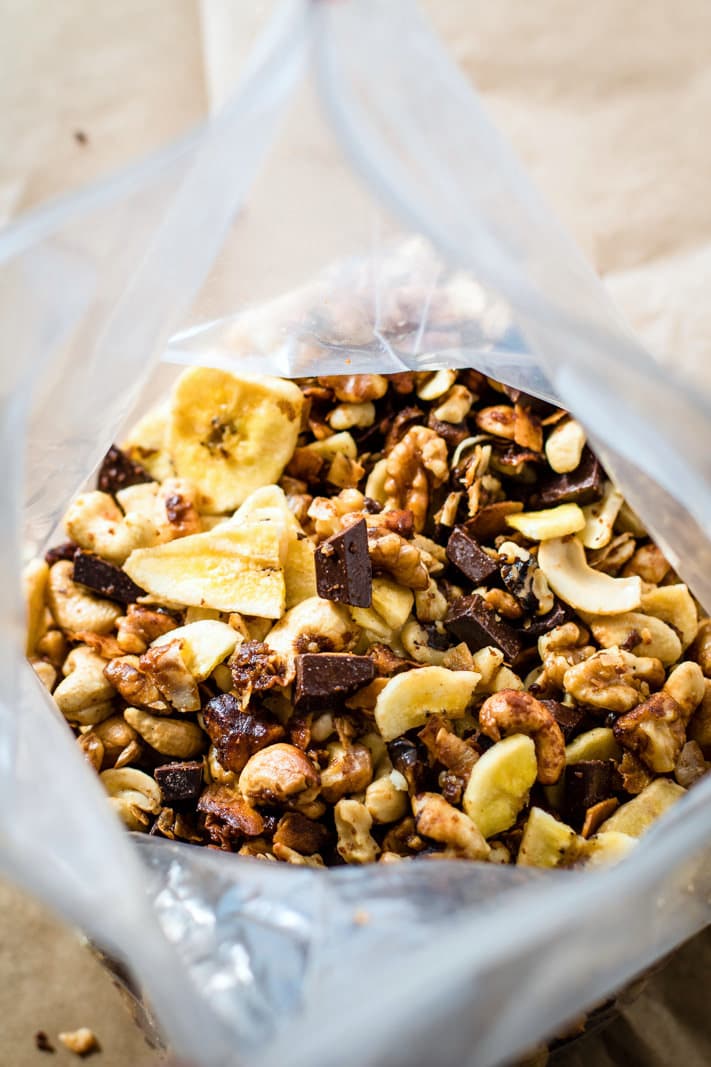 Crock Pot Chunky Monkey Paleo Trail Mix! A healthy gluten free trail mix that will definitely give you energy, whether actually on a trail or snacking on the go! This chunky monkey paleo trail mix is one that you can make easy in the crockpot and you can make lots of it. Get ready to munch on a handful mix of nuts, coconut, dark chocolate fudge chips, banana chips, and more!