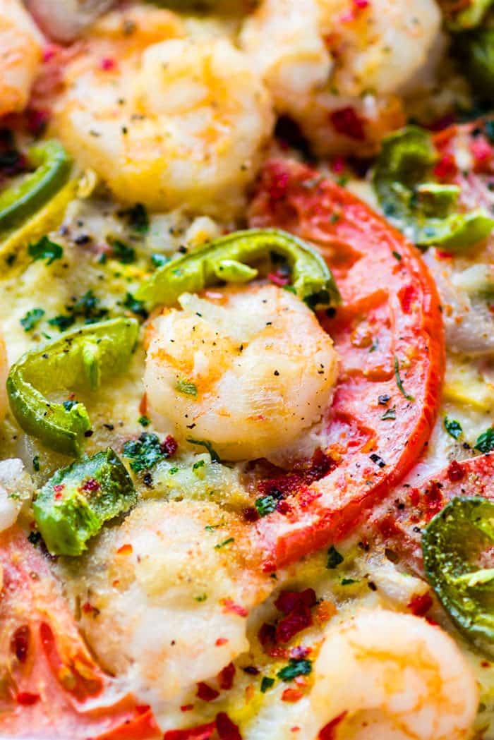 Close up view shrimp and tomatoes in an egg bake