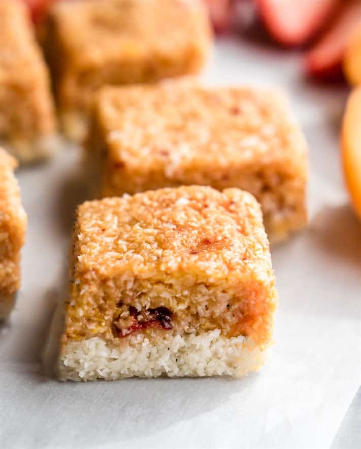 No Bake Fruity Vegan coconut ice squares! This tasty coconut ice recipe is easy to make, doesn’t need cooking, and is quick to put together. All it takes is five ingredients and a bit of time in the fridge. Plus it's dye free, healthier that the classic coconut ice candy, gluten free, and perfect for desserts!