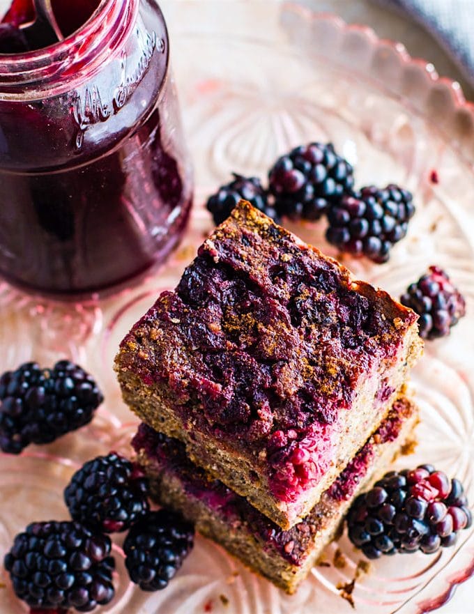 gluten free quinoa cakes with blackberries stacked up on each other.
