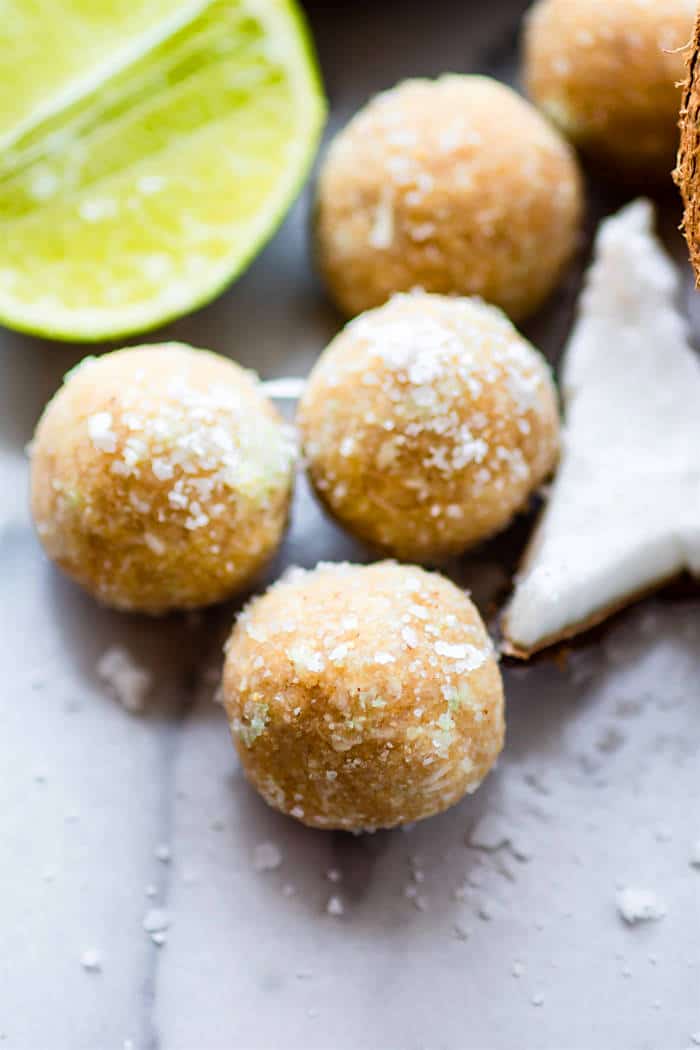 No Bake Coconut Margarita Bites! Super simple no bake coconut margarita treats in dessert bite form! These bites are naturally gluten free, paleo friendly, and vegan! Bites that actually taste like a frozen margarita with natural lime and coconut flavors. So refreshing for summer or anytime of year! @cottercrunch