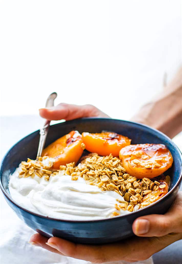 Gluten Free Char-grilled apricot parfait dessert bowls! These dessert bowls are great for a dessert  or a breakfast. A light and simple dessert that's layered with glazed grilled apricots, whipped coconut cream, and wholesome granola. Vegan Friendly. 