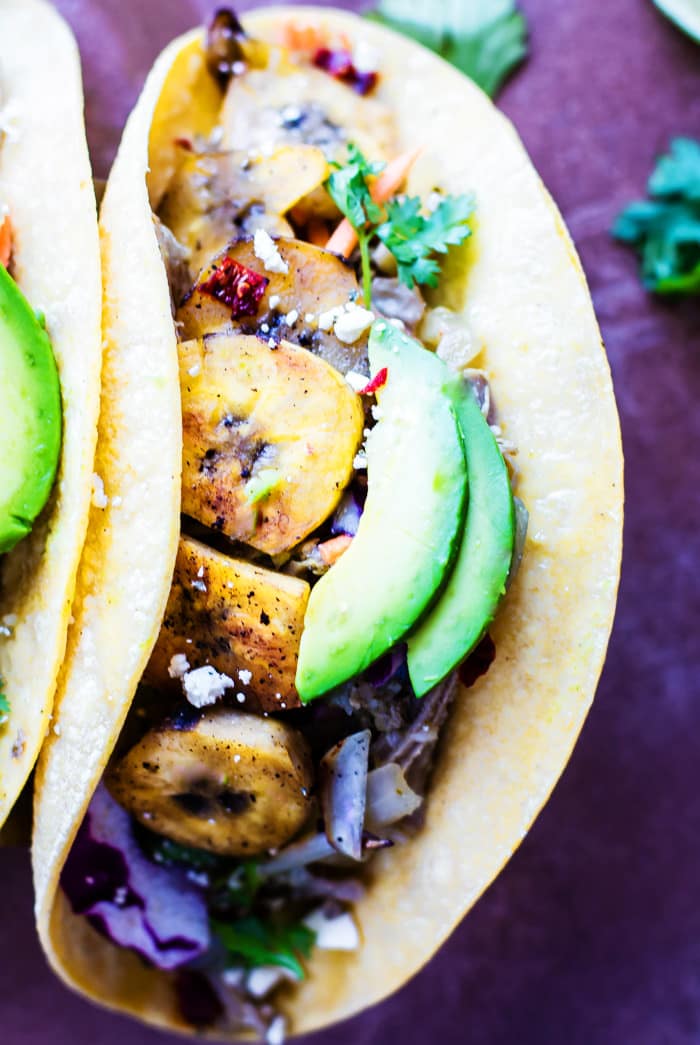 Crock Pot Cuban Pork Tacos with fried plantains! A NEW gluten free recipe you're gonna LOVE! These crock pot pork tacos are light, citrusy, and naturally sweetened with a plantain cabbage topping. Easy peasy weeknight meal or make ahead for multiple meals!