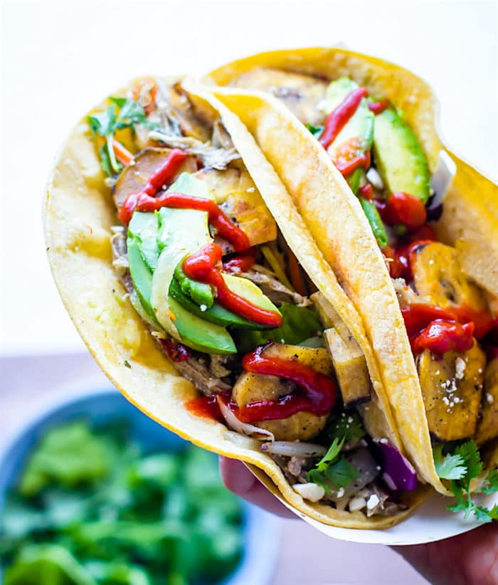 Healthy and Easy Crock Pot Cuban Pork Tacos recipe with fried plantains! These delicious crock pot pork tacos are light, citrusy, and naturally gluten free. Clean eating, simple ingredients, so tasty! @cottercrunch