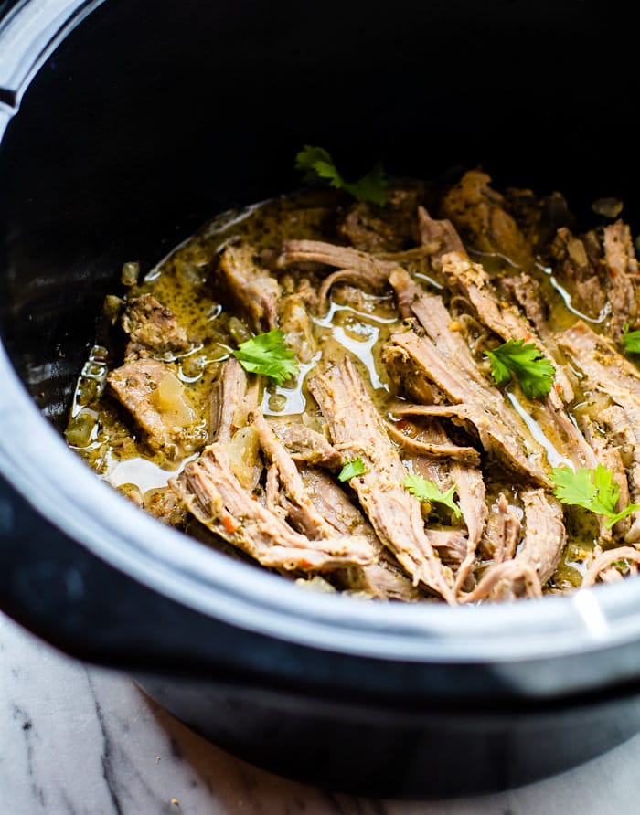 Delicious and Easy Crock Pot Cuban Pork Tacos with fried plantains! These healthy crock pot pork tacos are light, citrusy, and naturally sweetened with a plantain cabbage topping. Naturally gluten free and wholesome. Perfect for week night family meals or for make ahead multiple meals!