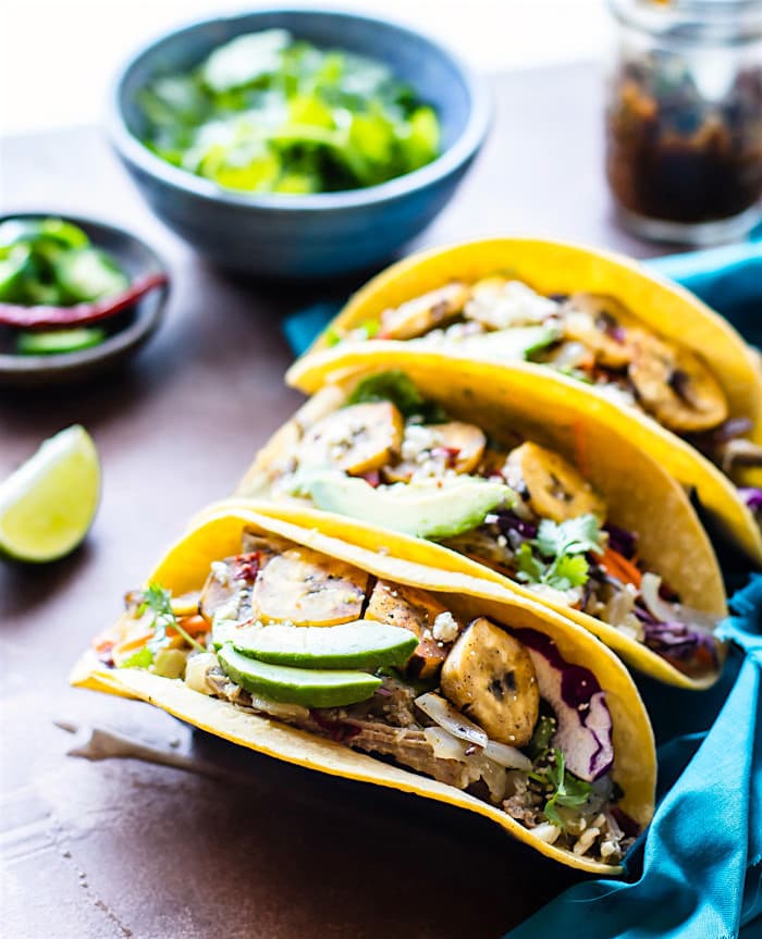 Delicious and Easy Crock Pot Cuban Pork Tacos with fried plantains! These healthy crock pot pork tacos are light, citrusy, and naturally sweetened with a plantain cabbage topping. Naturally gluten free and wholesome. Perfect for week night family meals or for make ahead multiple meals!