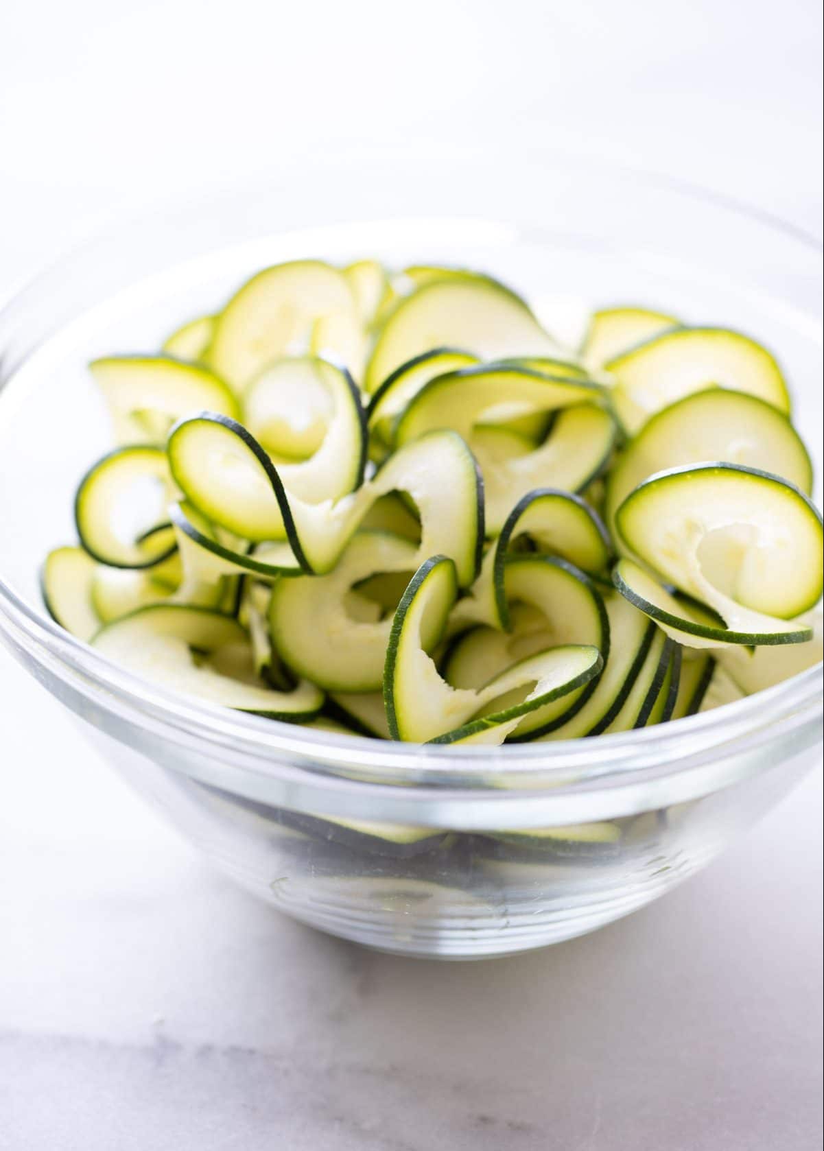 zucchini noodles in clear glass bowl