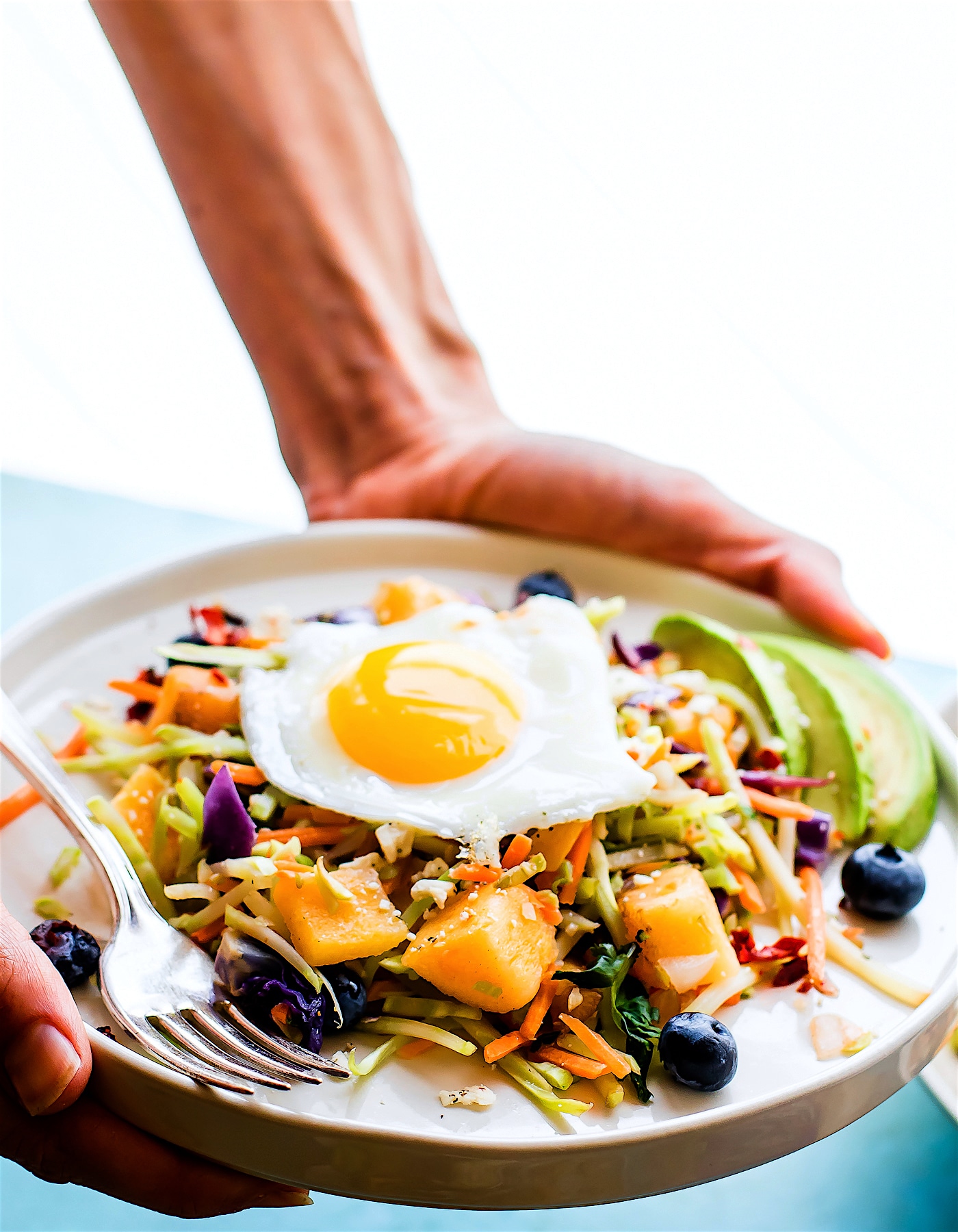 Breakfast salad to start the day! A nourishing warm Paleo meal with broccoli slaw, squash, berries, and fried eggs. A breakfast salad worth waking up for! #whole30
