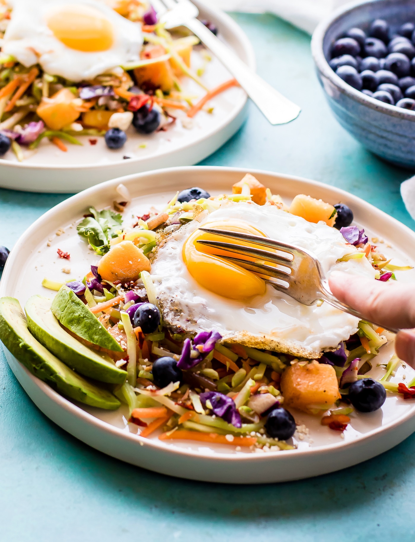 Breakfast salad to start the day! A nourishing warm Paleo meal with broccoli slaw, squash, berries, and fried eggs. A breakfast salad worth waking up for!