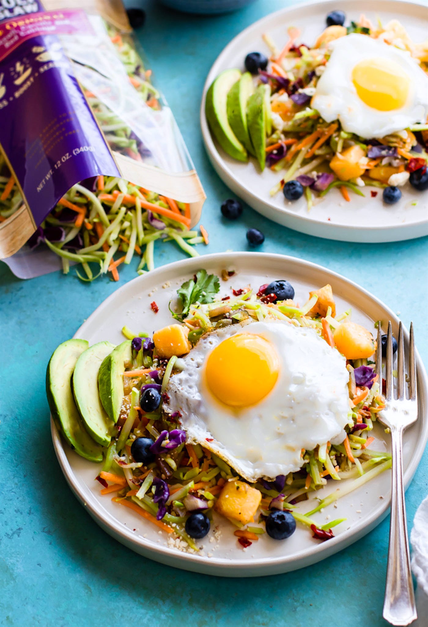 Breakfast salads are the best way to start the day! Create a healthy warm Paleo morning meal with lightly cooked broccoli cole slaw, onion, and squash topped with seasonal fruit and a protein rich fried egg! A nourishing breakfast salad worth waking up for! Easy, delicious, nutritious!