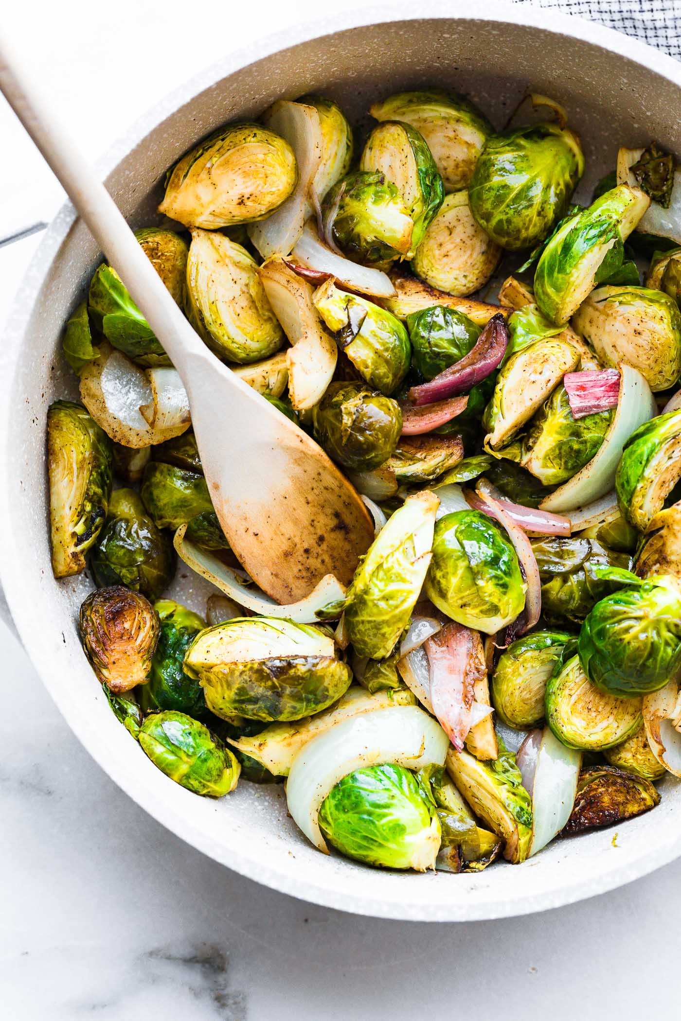 Creamy Mustard sauteed Brussel Sprouts Salad! A Brussel Sprouts superfood salad tossed in a vegan creamy mustard sauce. An easy to make paleo side dish!