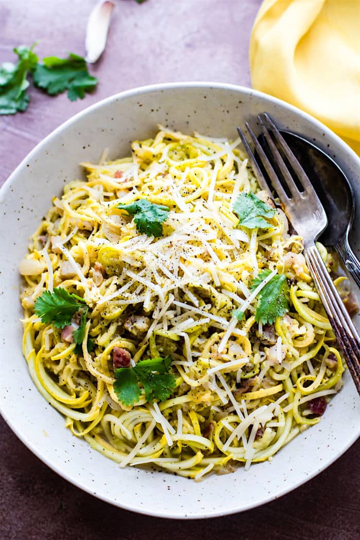 Quick Spiralized Squash Carbonara with Pancetta! Delicious spiralized squash noodles, pan fried garlic and pancetta, and a creamy pasta carbonara sauce all tossed together. This low carb veggie pasta dish is super easy to make with a spiralizer, light, yet still comforting. Just like real pasta carbonara, but naturally gluten free!