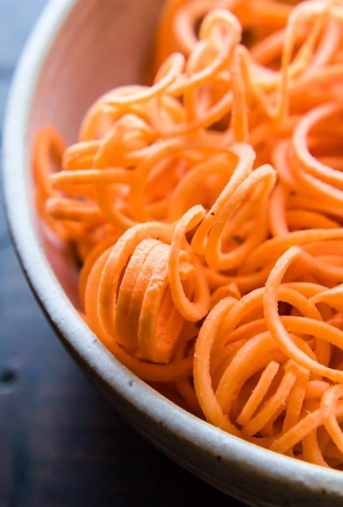 Close up view carrot noodles spiralized, in bowl